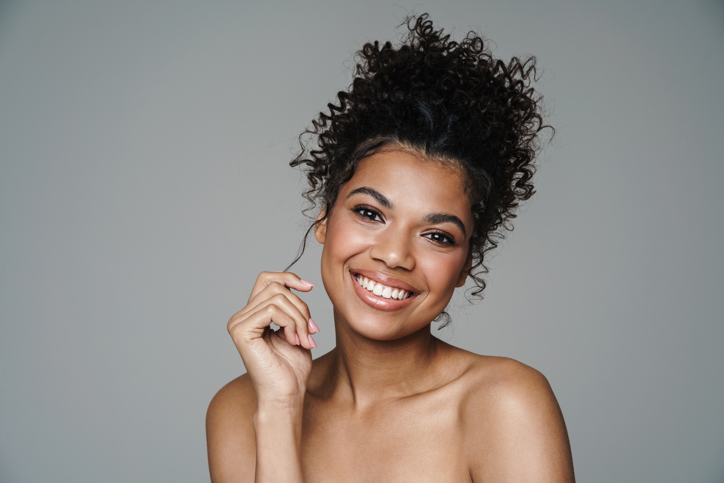 Image of Shirtless African American Woman Looking and Smiling at Camera